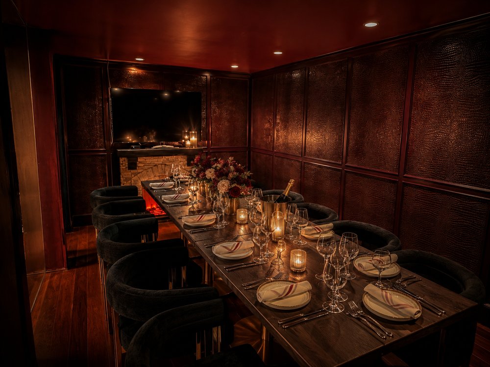 The private dining room set with candles along a long wooden table