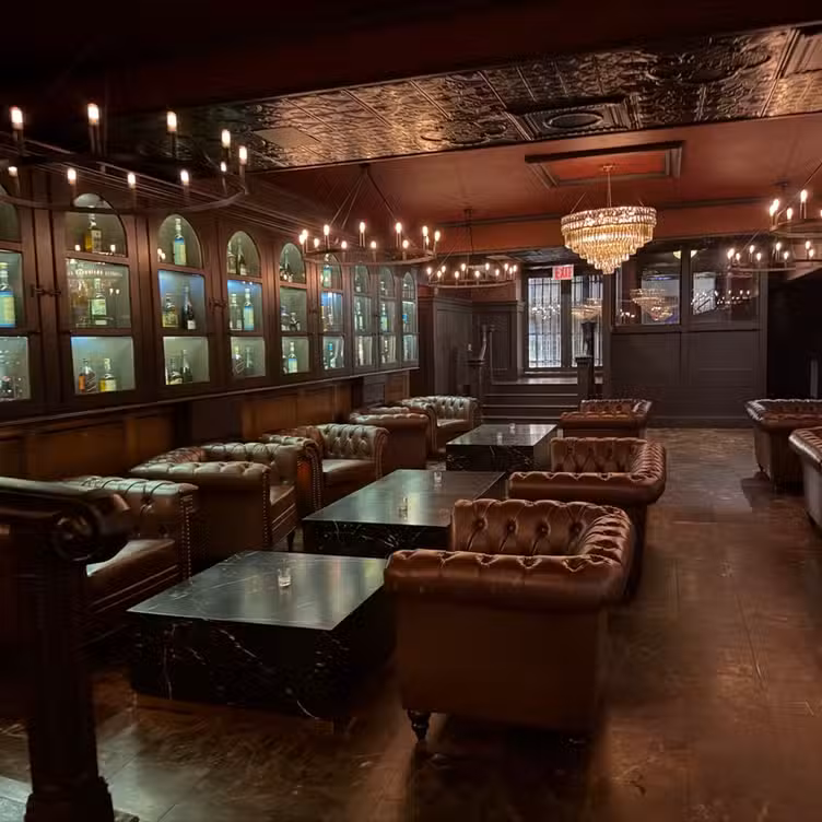 The backlit bar at Bueno with candlelit onyx counter